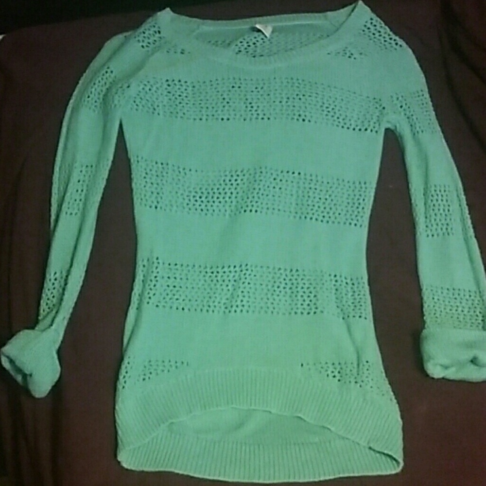 A long sleeved teal sweater.